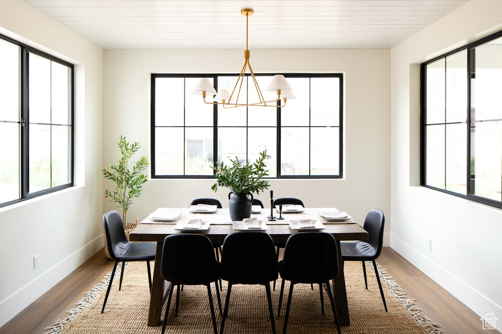 Dining space featuring hardwood / wood-style flooring and a chandelier