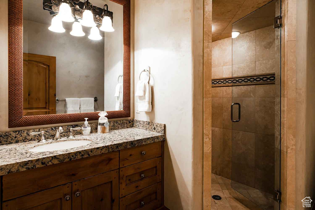 Bathroom featuring vanity and a shower with shower door