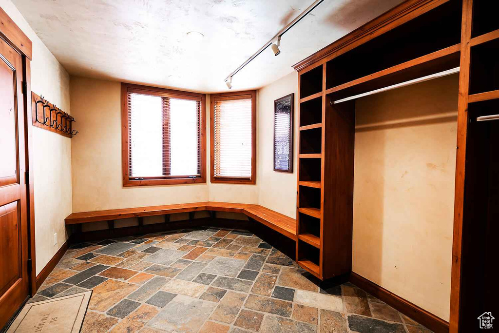 Spacious closet with dark tile flooring