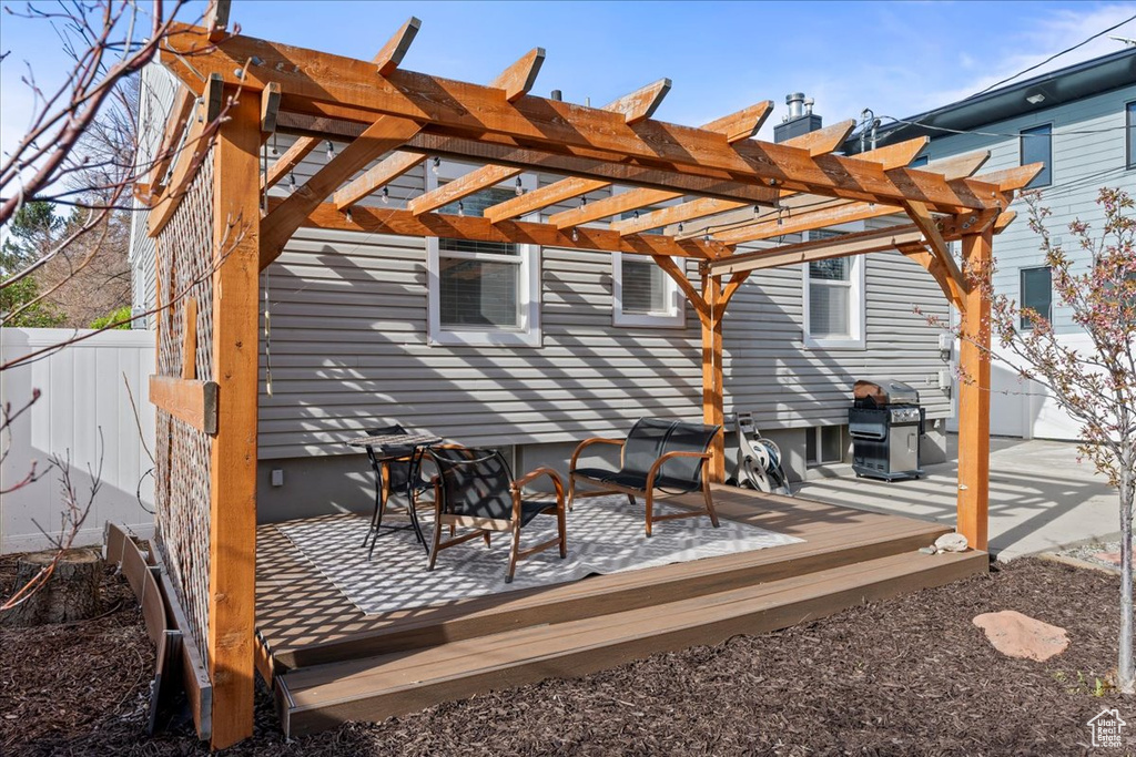Deck featuring a pergola and a grill
