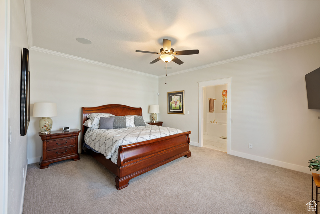 Bedroom featuring ornamental molding, light carpet, ceiling fan, and ensuite bathroom