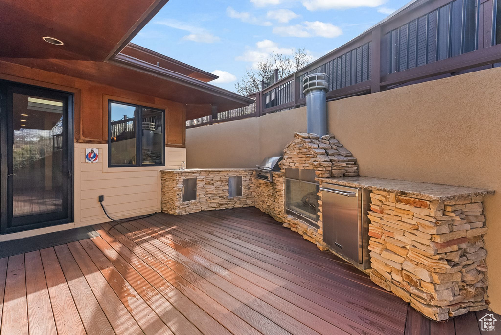 Deck featuring grilling area and exterior kitchen