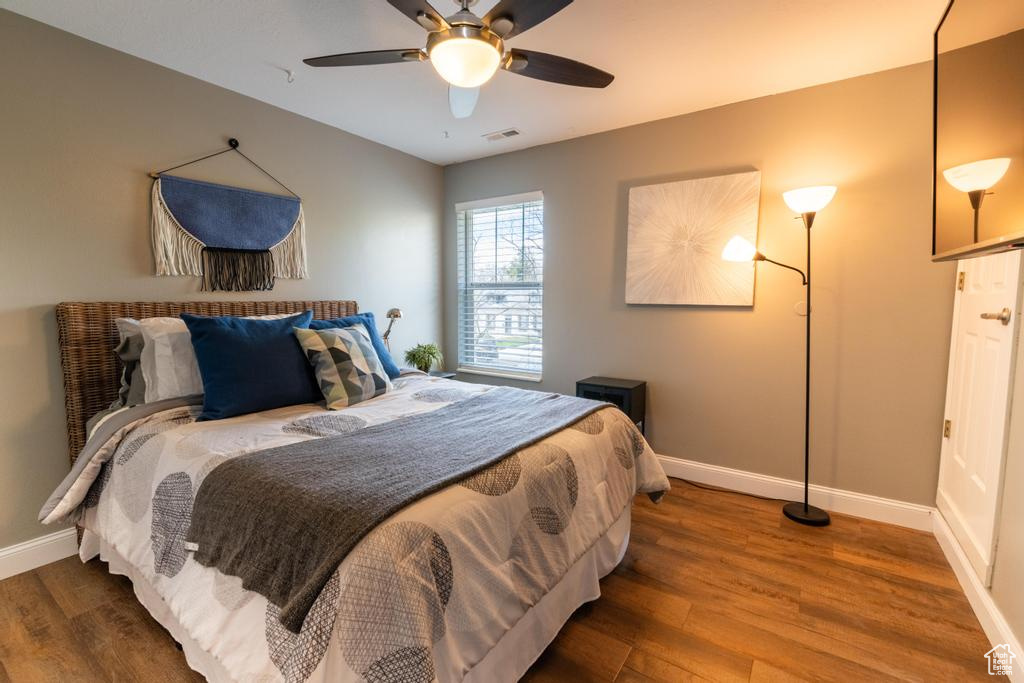 Bedroom featuring ceiling fan and dark hardwood / wood-style flooring