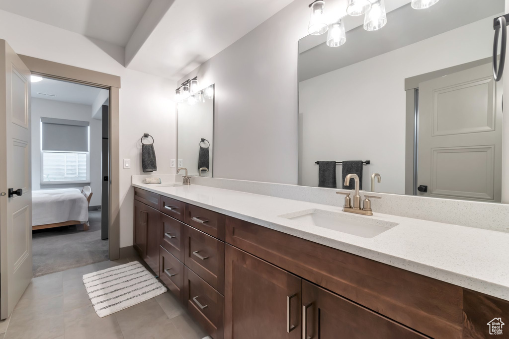 Bathroom with double vanity and tile floors