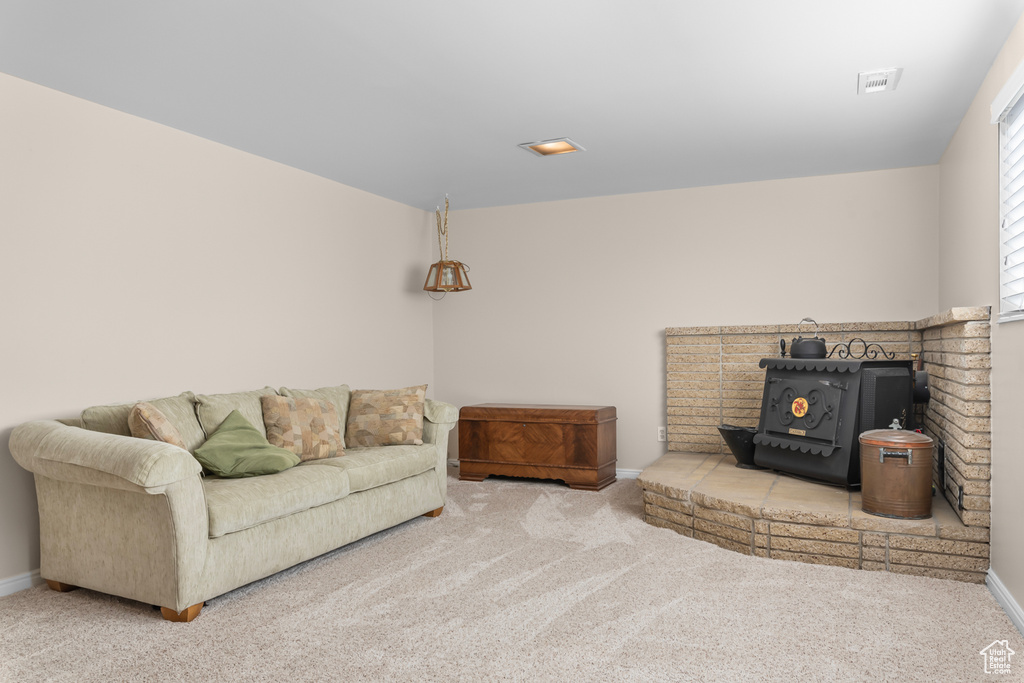 Living room with a wood stove and carpet flooring