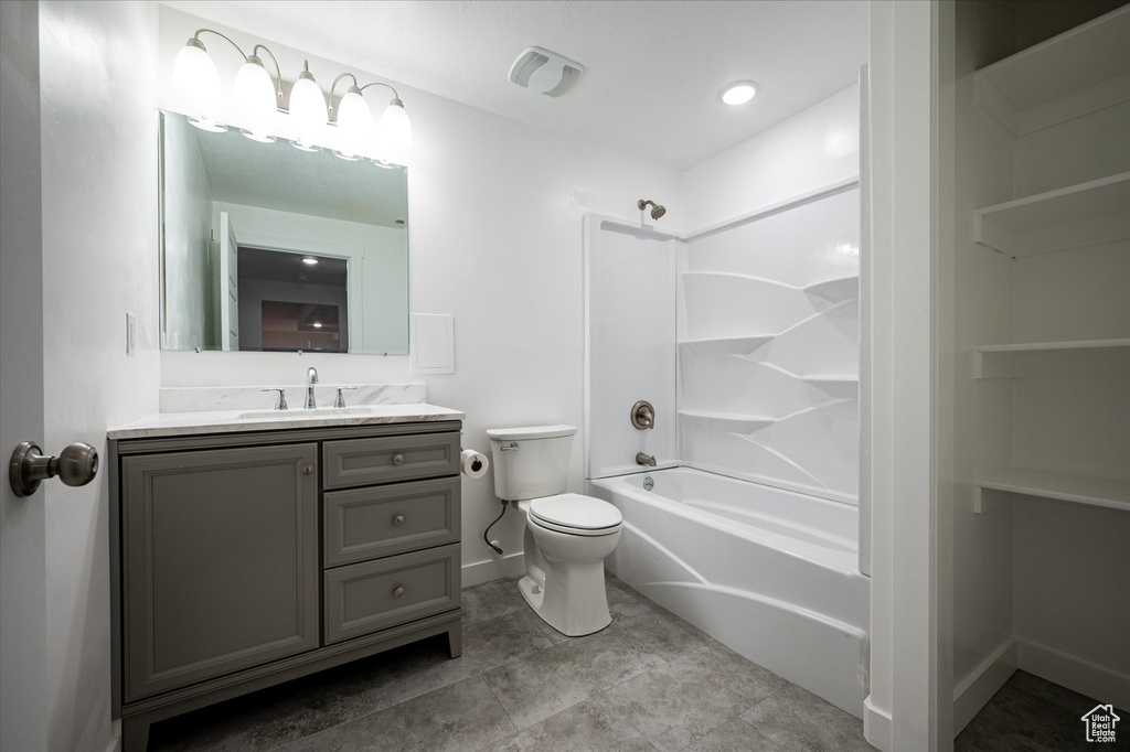 Full bathroom with tile floors, shower / bathing tub combination, toilet, and oversized vanity