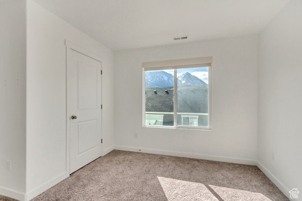 Unfurnished room with light colored carpet