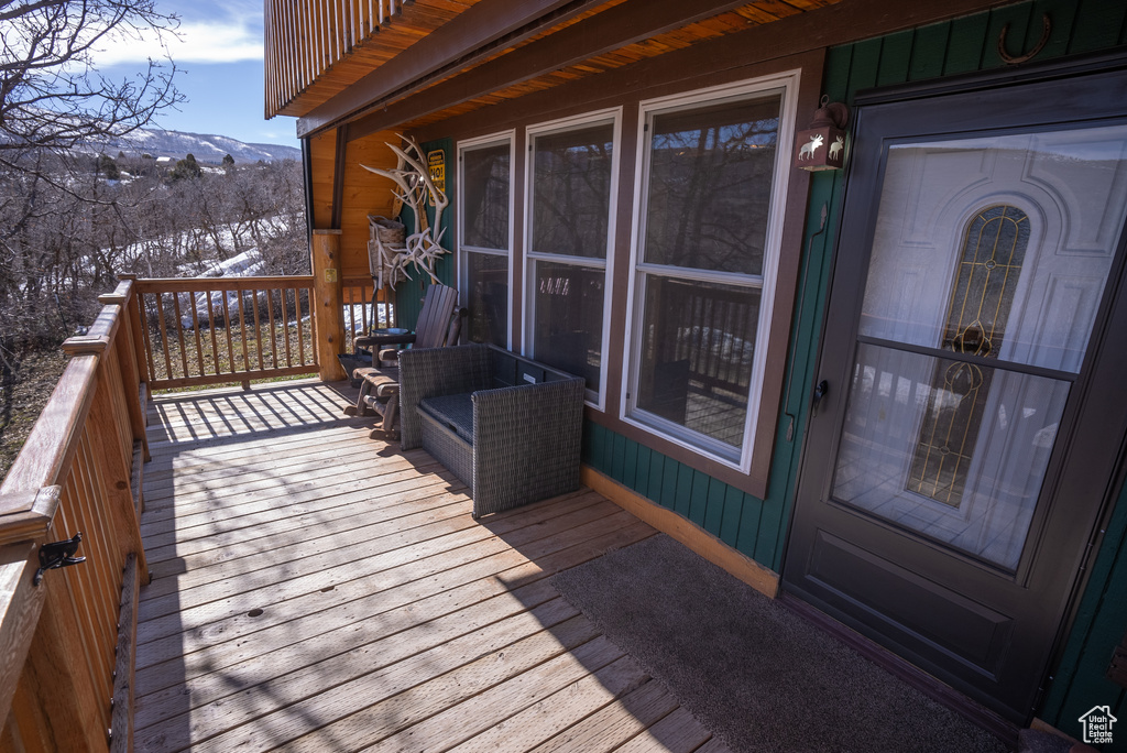 Snow covered deck featuring a mountain view