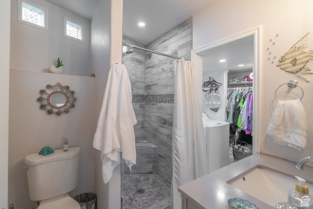 Bathroom with vanity, toilet, and a shower with curtain