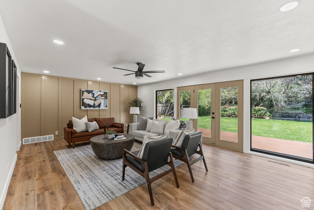 Living room featuring french doors, light hardwood / wood-style flooring, and ceiling fan