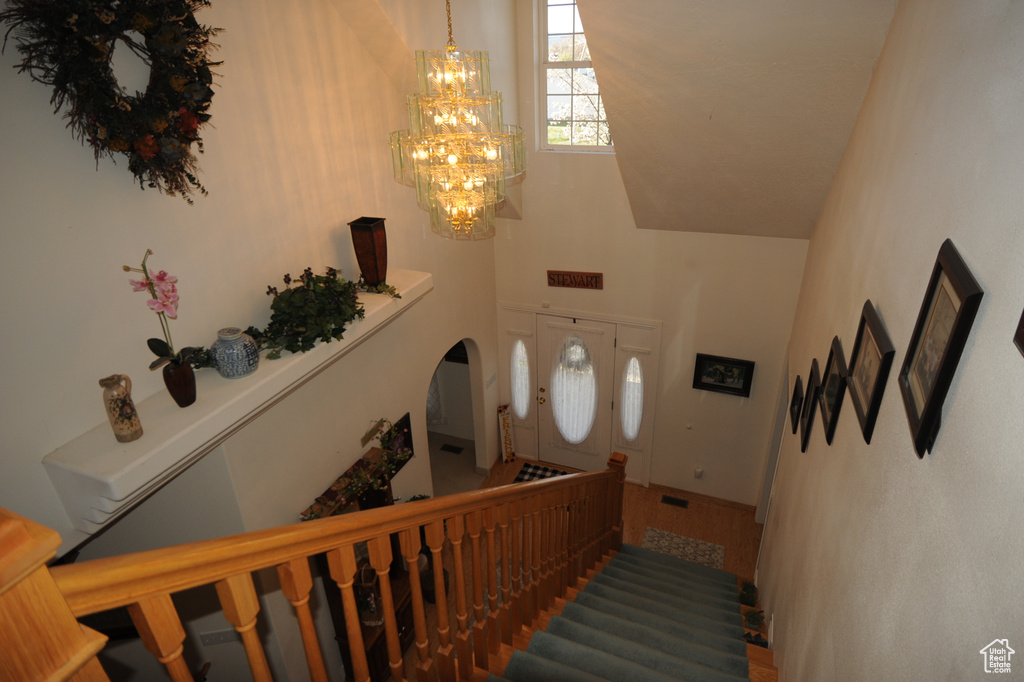 Stairway featuring a notable chandelier