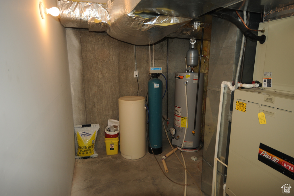 Utility room featuring water heater and heating utilities