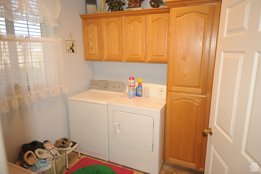Laundry area featuring cabinets and washer and dryer