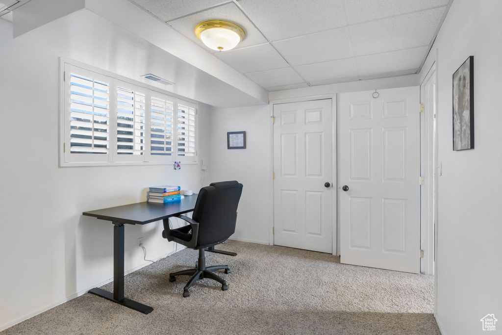 Office with light colored carpet and a drop ceiling