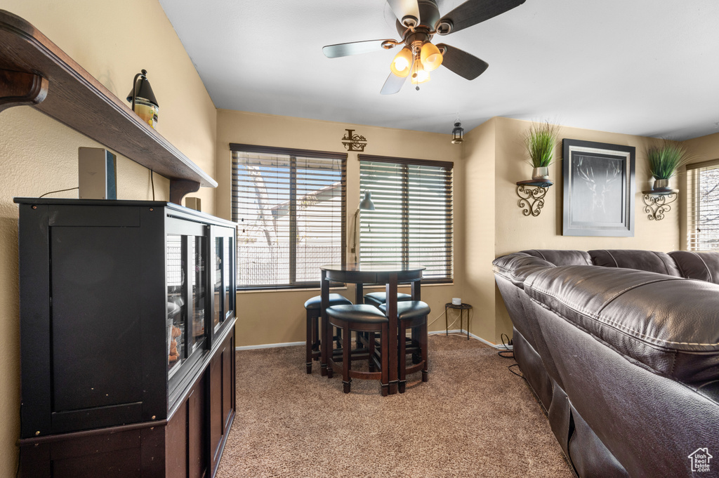 Interior space with ceiling fan and carpet flooring