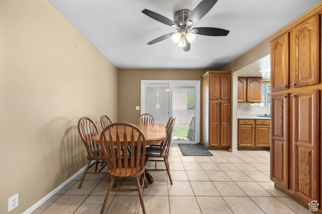 Dining area with ceiling fan and light tile floors