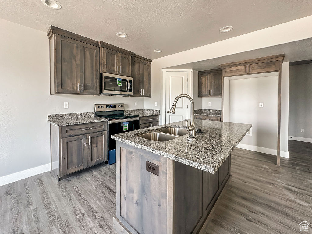 Kitchen featuring sink, light hardwood / wood-style flooring, and stainless steel appliances