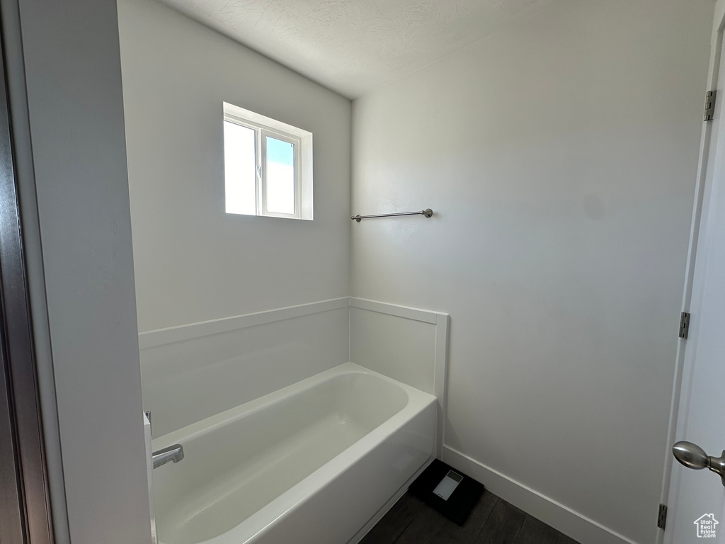 Bathroom featuring a bathtub and a textured ceiling