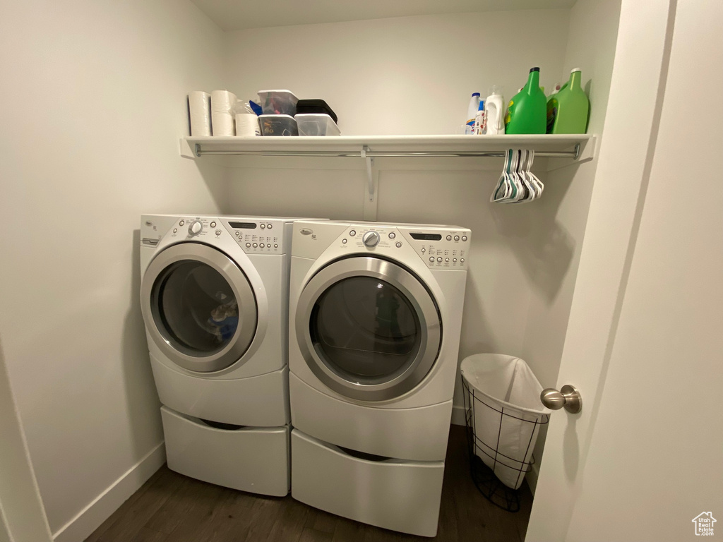 Clothes washing area featuring dark hardwood / wood-style flooring and separate washer and dryer