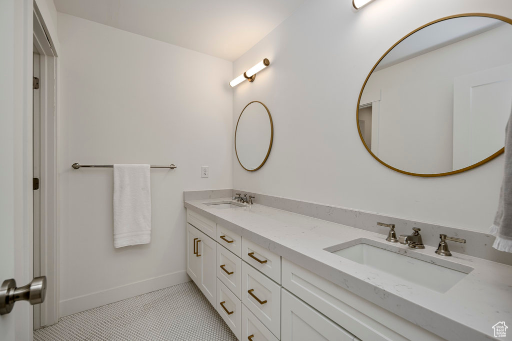 Bathroom with dual bowl vanity and tile floors