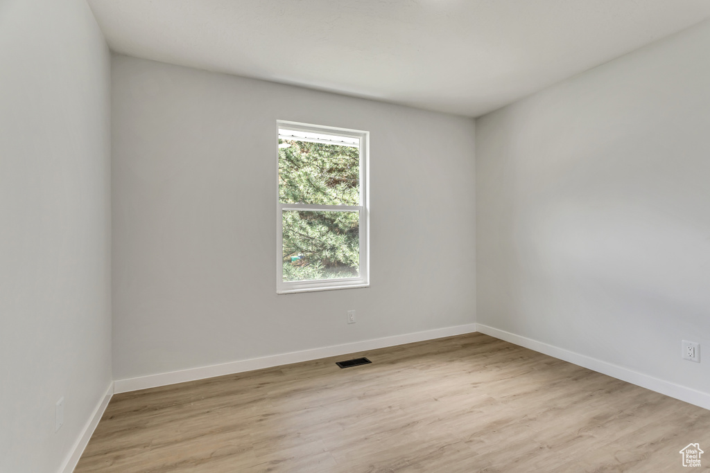 Unfurnished room featuring a wealth of natural light and light hardwood / wood-style floors