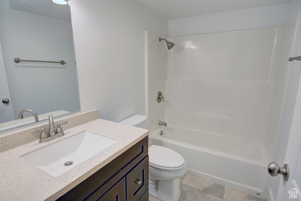 Full bathroom featuring tile flooring, shower / bath combination, toilet, and large vanity