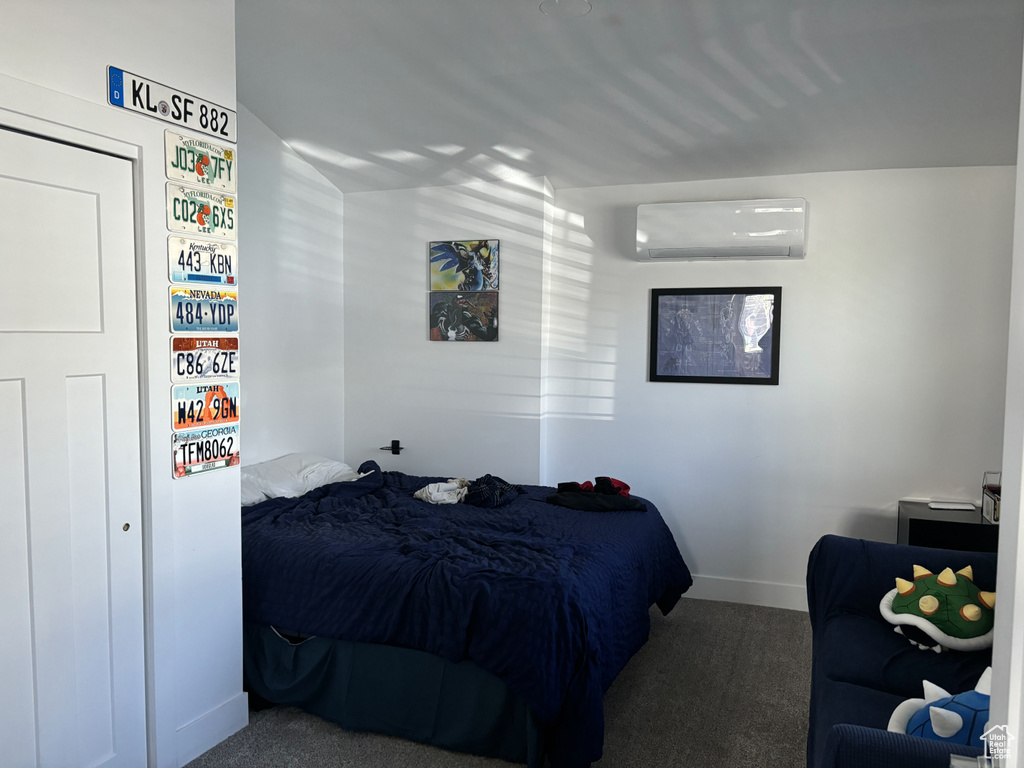 Carpeted bedroom with a wall mounted AC