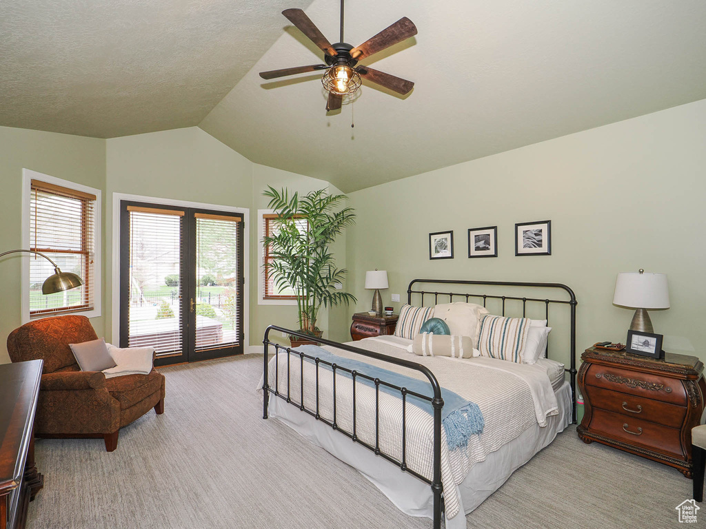Carpeted bedroom with lofted ceiling, ceiling fan, and access to exterior