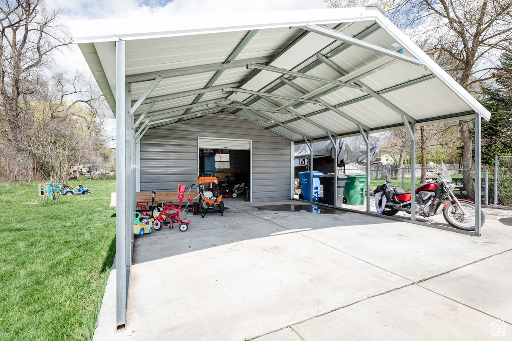 View of car parking with a lawn and a carport