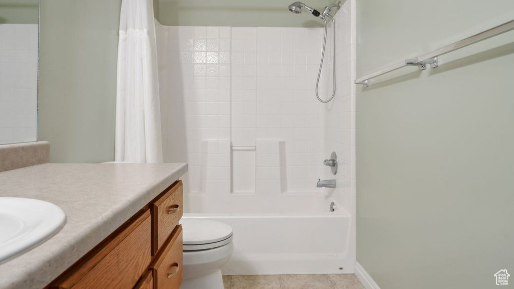 Full bathroom with vanity, shower / tub combo, toilet, and tile flooring