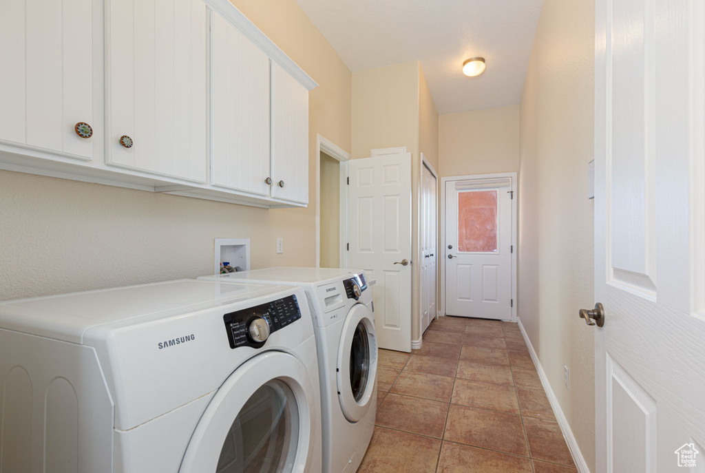Washroom featuring independent washer and dryer, washer hookup, cabinets, and light tile floors