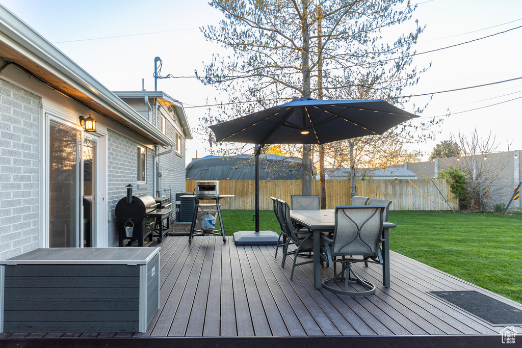Wooden deck with a yard and grilling area