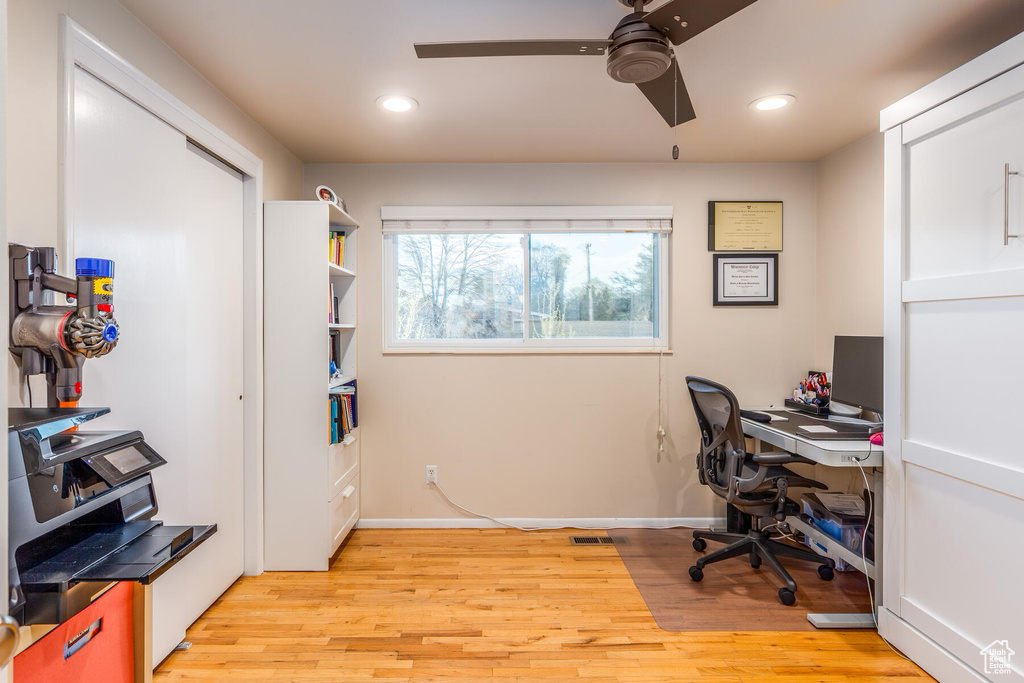 Home office with ceiling fan and light wood-type flooring