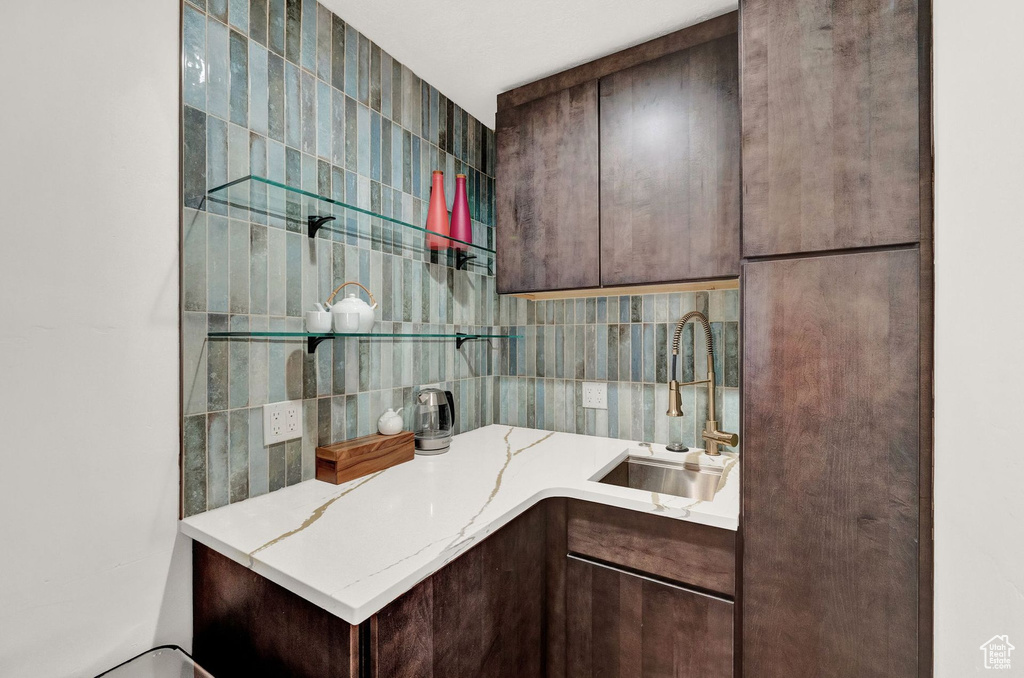 Bathroom with tile walls, vanity, and backsplash