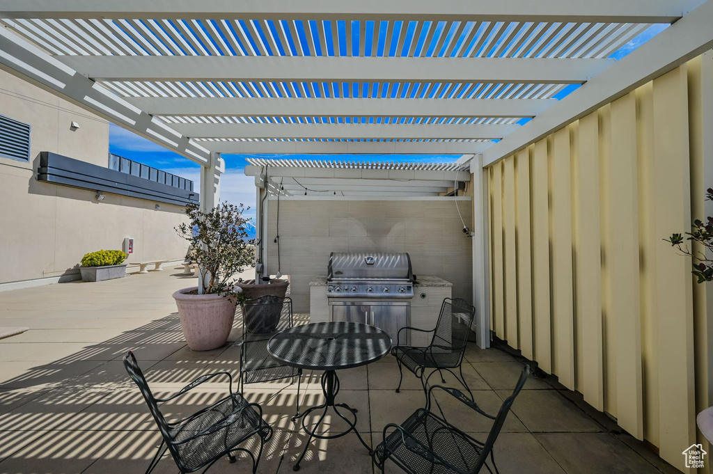 View of patio featuring a grill, area for grilling, and a pergola