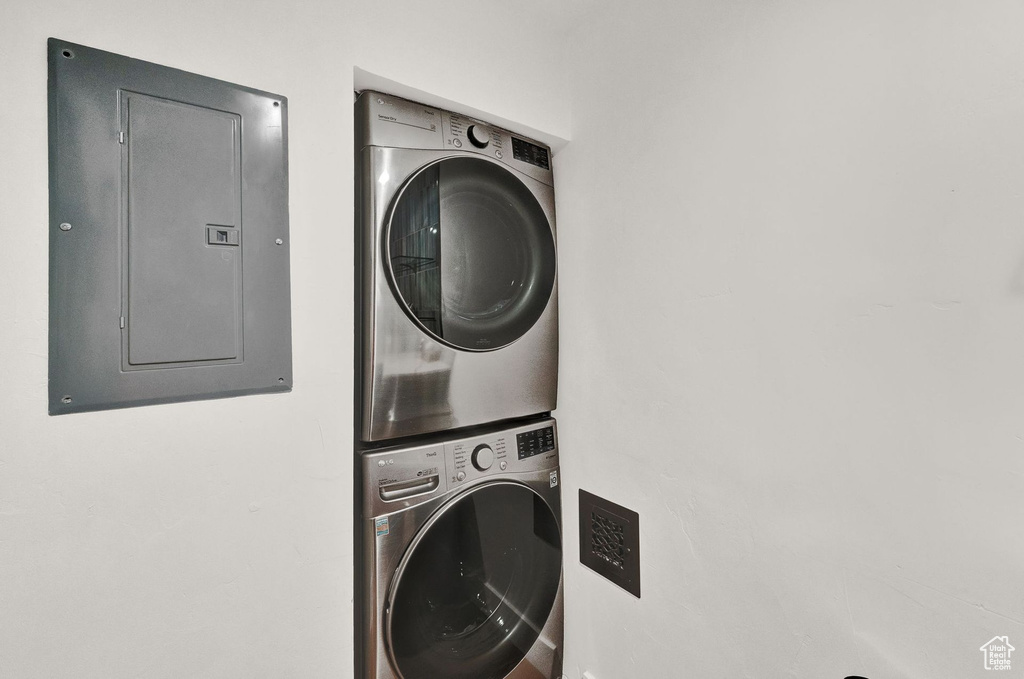 Laundry room with stacked washer and clothes dryer