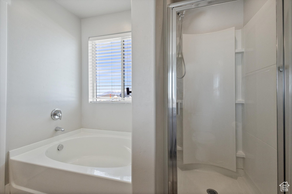 Bathroom featuring plenty of natural light and separate shower and tub