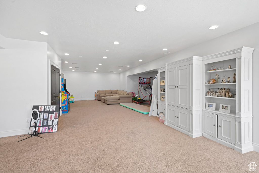 Game room featuring built in features and light colored carpet