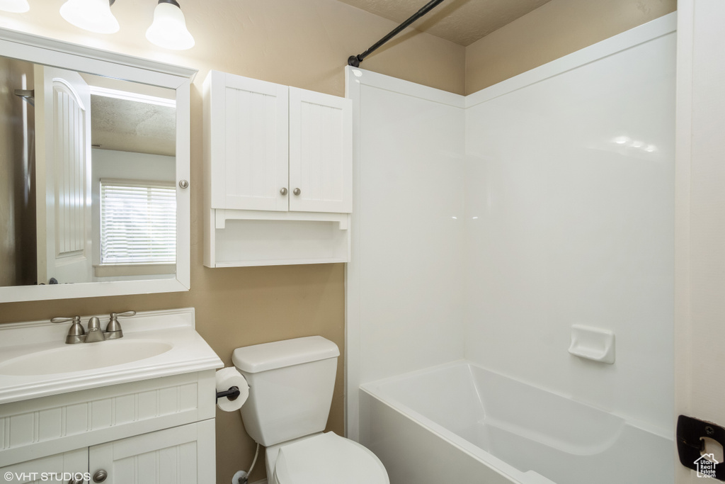 Full bathroom featuring vanity, toilet, and bathing tub / shower combination