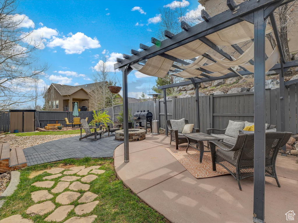 View of patio / terrace featuring a grill, a fire pit, and a pergola