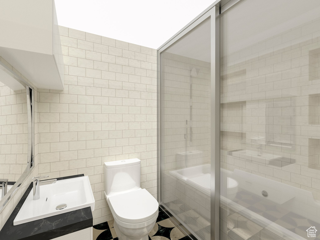 Bathroom featuring vanity, tile walls, tile flooring, a tile shower, and toilet