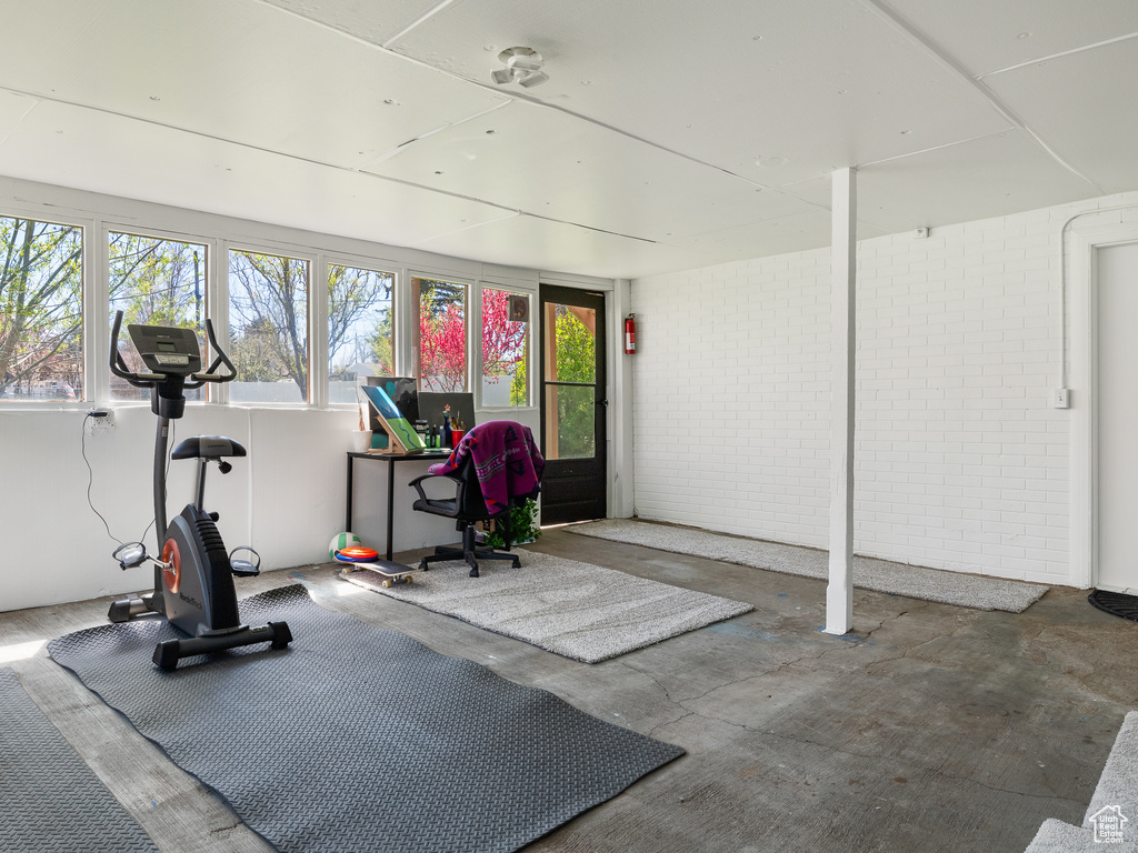 Workout area featuring a wealth of natural light and concrete floors