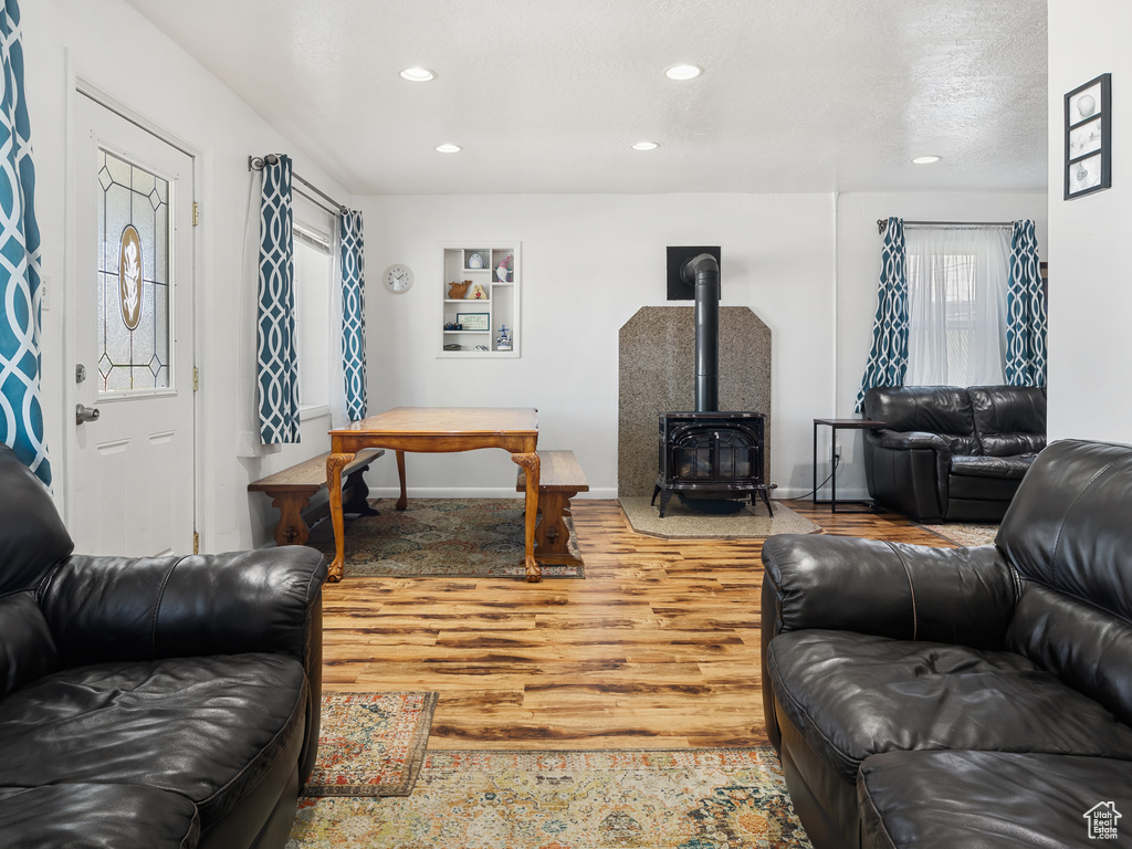 Living room featuring light wood-type flooring and a wood stove