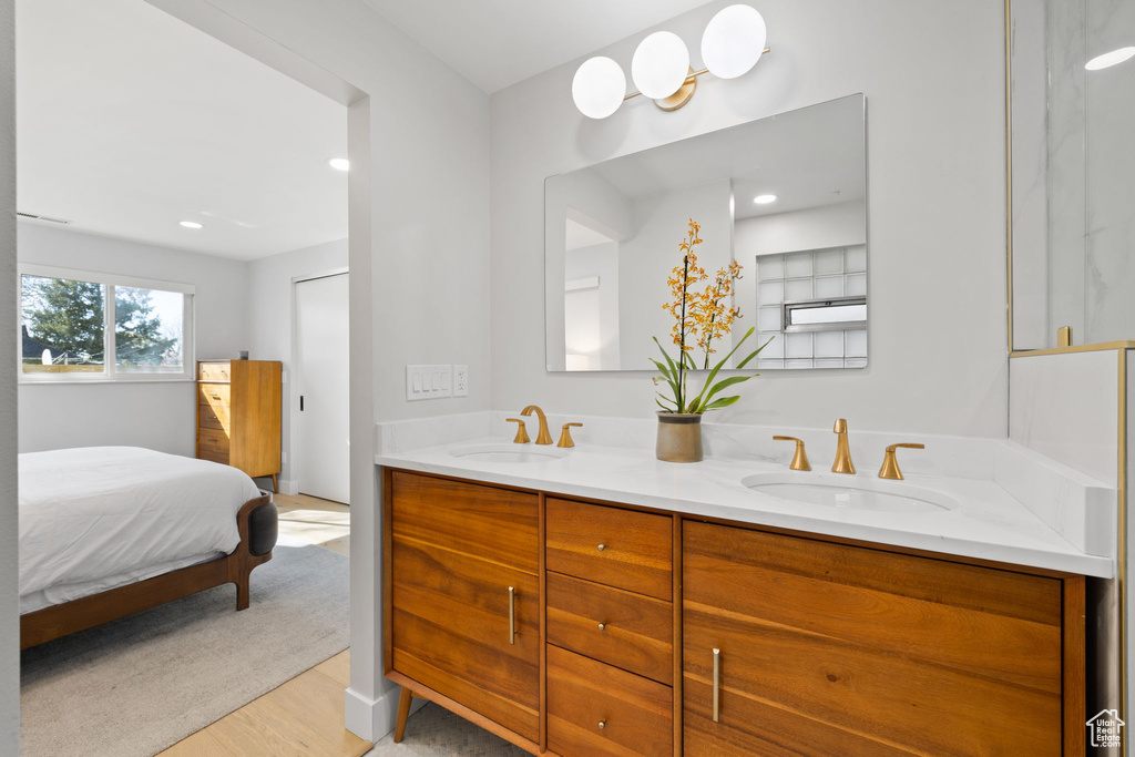 Bathroom with wood-type flooring and double sink vanity