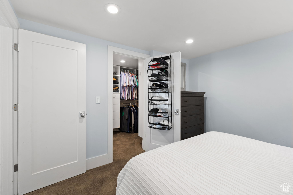 Carpeted bedroom with a closet and a walk in closet