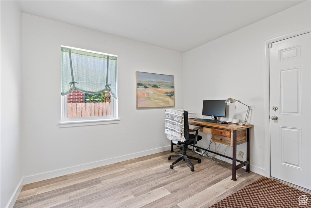 Office area with light hardwood / wood-style flooring
