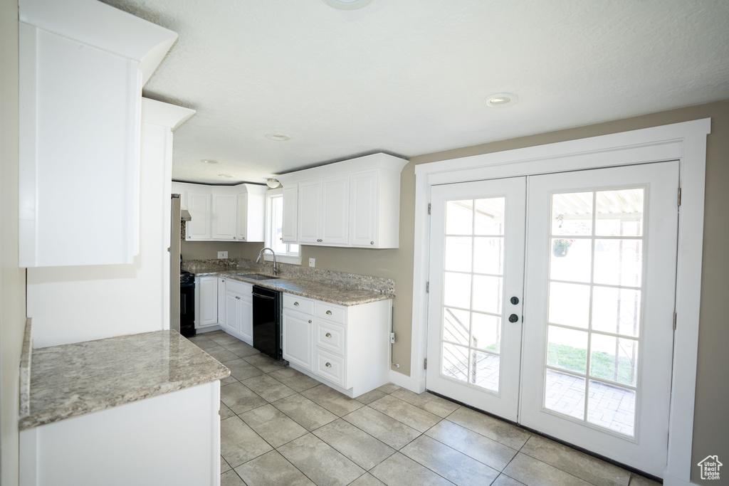 Kitchen with french doors, dishwasher, white cabinetry, sink, and light tile floors