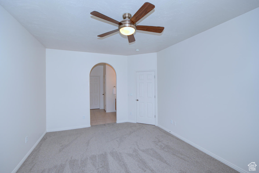 Unfurnished room featuring ceiling fan and light tile floors