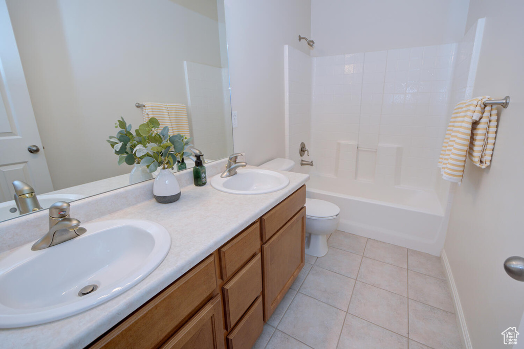 Full bathroom with double sink, tile flooring, shower / bath combination, and large vanity