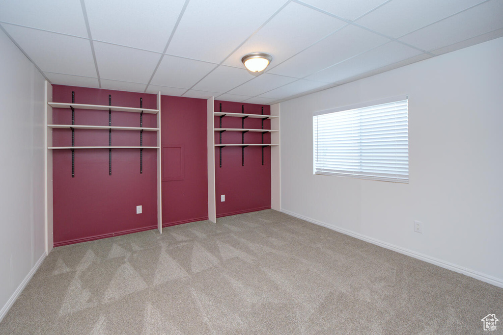 Spare room with light carpet and a paneled ceiling